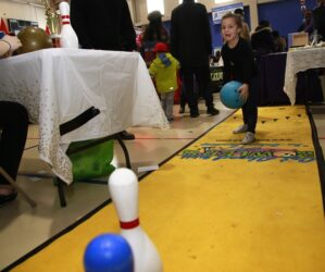 6-year old Zoey D'Agostino takes aim at the Maple Lanes bowling pins.