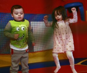 3-year old Tyler Every and 4-year old Sofie Penafiel bounce in the bouncy castle.