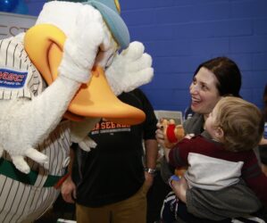 Quacker Jack from the LI Ducks plays peek-a-boo with 10-month old Benjamin Tarasuk and his mom Debbie.