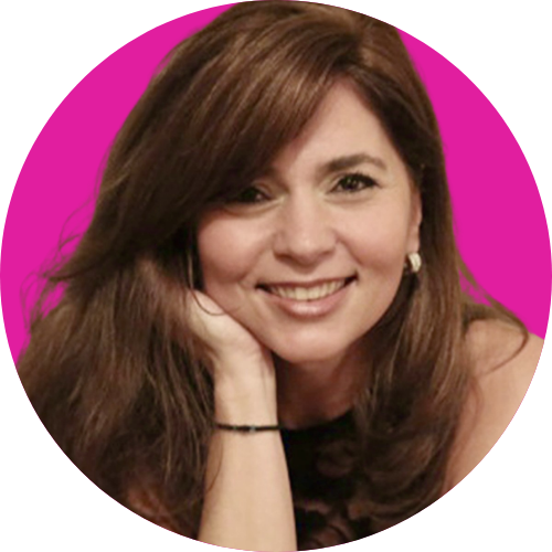 Smiling woman with long brown hair resting her chin on her hand, against a magenta background.
