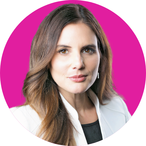 Professional headshot of a woman with long brown hair in a white blazer against a magenta circular background.