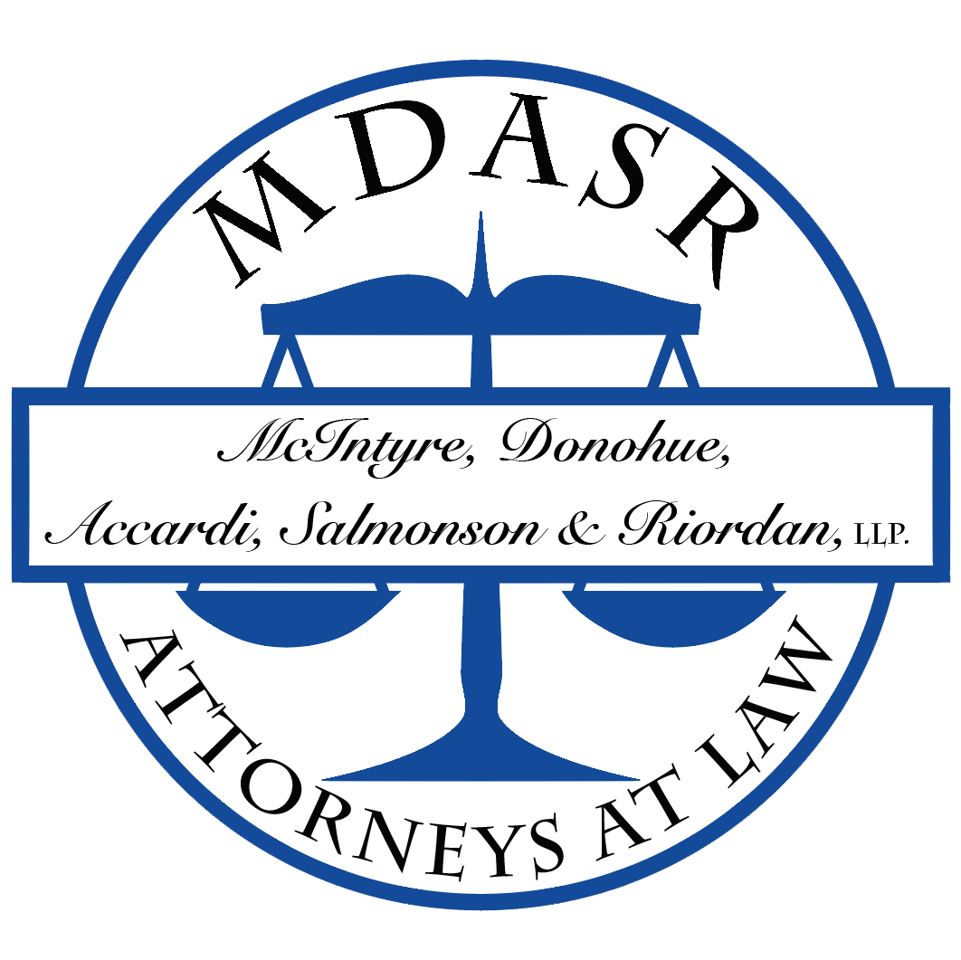 Circular law firm logo featuring blue scales of justice, outer text 'ATTORNEYS AT LAW' and banner with 'McIntyre, Donohue, Accardi, Salmonson & Riordan, LLP'