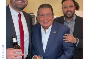 Three men in suits pose for a photo at a law awards event, one holding a beer and another a cocktail, with Top Lawyers of Long Island branding above them.