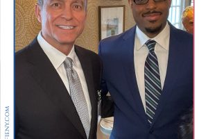 Two men in suits posing for a photo at the 2026 Top Lawyers of Long Island event off a formal setting with framed artworks in the background, smiling for the camera.