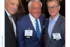 Three men in suits posing at a reception with name badges, framed by 'Top Lawyers of Long Island' branding.