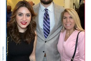 Three people posing together at a formal event, framed by a 'Top Lawyers of Long Island' graphic at the top of the frame.