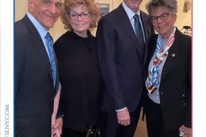 Four professionally dressed individuals posing together at a law event, framed by a 'Top Lawyers of Long Island' border and event branding at bottom and sides.