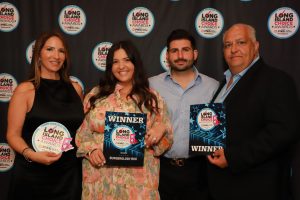 Four people pose on a red carpet backdrop labeled Long Island Choice Awards; two are holding winner plaques.