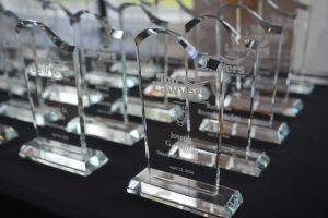 Crystal award reading 'Top Lawyers' on a black table, rows of similar trophies in the background.