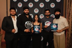 Five award winners pose together at a Long Island Choice Awards event, holding plaques and certificates in front of a branded backdrop.