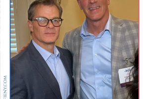 Two suited men posing together at a legal awards event, one holding a wine glass, with the Top Lawyers of Long Island logo above.