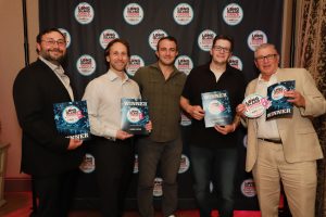 Five men stand in front of a Long Island Choice Awards backdrop, each holding winner certificates or plaques.