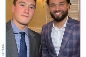 Two men in suits pose for a photo at a law awards event labeled 'Top Lawyers of Long Island' with branding above.