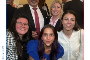 Group photo of five professionals at a formal event, smiling and holding wine glasses, Top Lawyers of Long Island 2026.