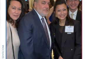 Group of professionals at a 2026 Top Lawyers of Long Island event; woman honoree in foreground wearing a name badge on black blazer.