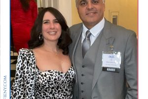 Smiling man in a gray suit and a woman in a leopard-print dress pose together at the 2026 Top Lawyers of Long Island awards event.